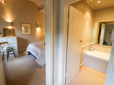 A bedroom with a bed and dresser at Foxhill Farm Barn Bourton-On-The-Water