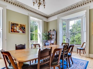 A dining room with a table and chairs at Fountain Hill House Londonderry