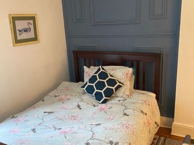 A bedroom with a bed and wall art at Fountain Hill House in Londonderry