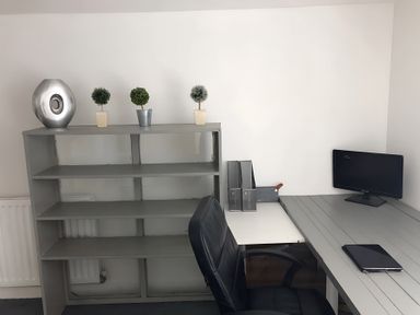 An office with a desk, computer monitor, and decorative plants at Fountain Hill House Londonderry
