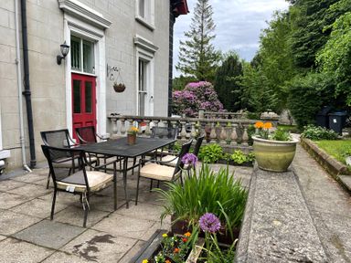 An outdoor seating area with a table and chairs at Fountain Hill House Londonderry