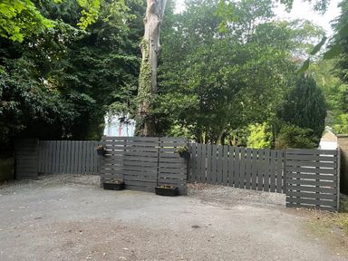 An outdoor area with a gray fence and flower pots at Fountain Hill House Londonderry