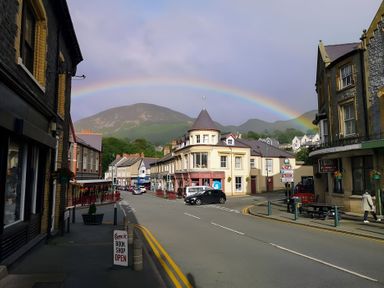 A street with buildings and a rainbow at Sea view cottage in Penmaenmawr