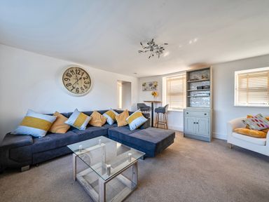 A living room with a sofa and coffee table at Sea view cottage in Penmaenmawr