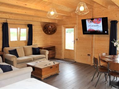 A living room with a sofa and dining table at Cotswold Nights Away in Evesham