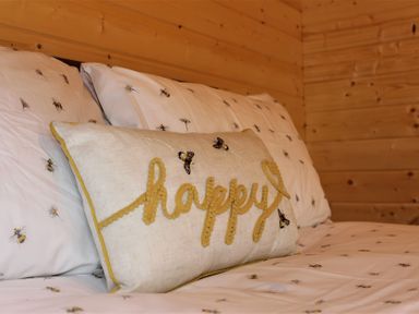 A bedroom with a bed and a decorative pillow at Cotswold Nights Away in Evesham