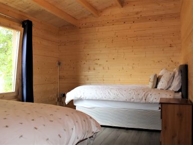 A bedroom with beds and a window at Cotswold Nights Away in Evesham