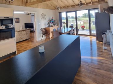 A kitchen with a large island and dining area at Fox Lodge in York