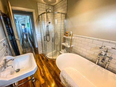 A bathroom with a bathtub and shower at Fox Lodge in York