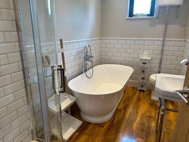 A bathroom with a bathtub and shower at Fox Lodge in York