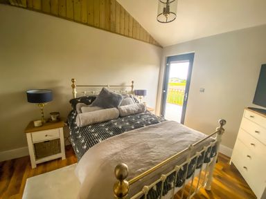 A bedroom with a bed and door leading outside at Fox Lodge in York