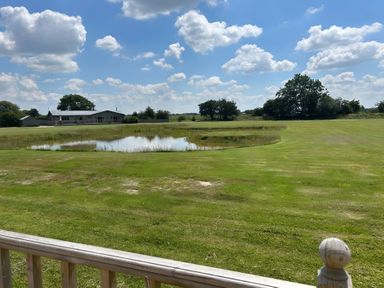 An outdoor view of a house and pond at Fox Lodge in York