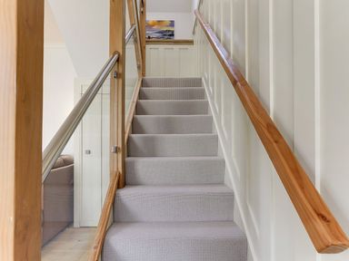 Stairs leading to upper level with a handrail at Poppyfields Stable Redruth