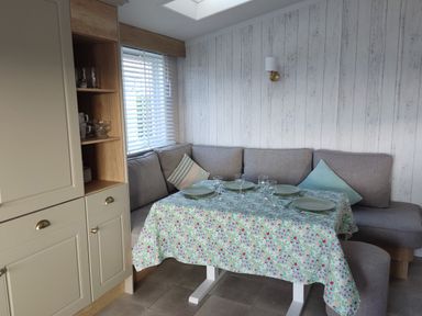 A dining area with a table set for meals at Harbour View in Poole