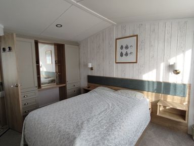 A bedroom with a bed and wardrobe at Harbour View in Poole
