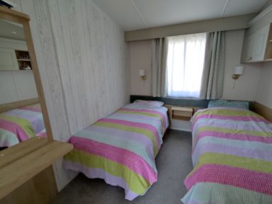A bedroom with two beds and a window at Harbour View in Poole