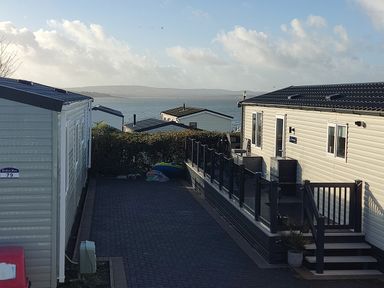 An outdoor space with caravans and view of the sea at Harbour View in Poole