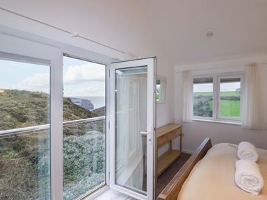 A bedroom with a bed and a table at Poldreth in Truro