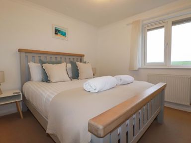 A bedroom with a bed and pillows at Poldreth in Truro