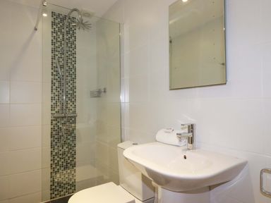 A bathroom with shower, toilet and sink at Poldreth in Truro