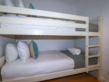 A bunk bed with pillows and towels at Poldreth in Truro