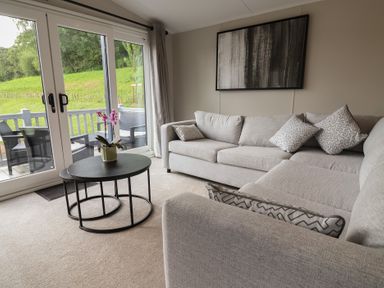 A living room with a sofa and coffee table at The Pines 3 Bedrooms in Delamere