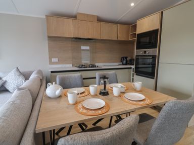 A kitchen with a table set for tea at The Pines 3 Bedrooms Delamere