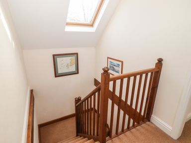 A staircase with framed pictures and a skylight at Rhosgranog Cottage Llandeloy near Solva