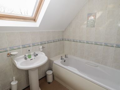A bathroom with a sink and bathtub at Rhosgranog Cottage Llandeloy near Solva