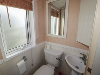 A bathroom with a toilet and sink at Rhosgranog Caravan Llandeloy near Solva