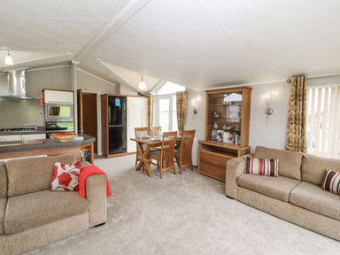 A living room and kitchen area at No 8 Hillcote Lodge in Cockermouth