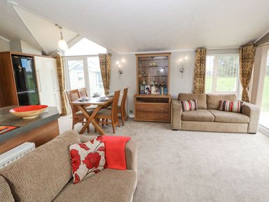 A living room with a dining area at No 8 Hillcote Lodge in Cockermouth
