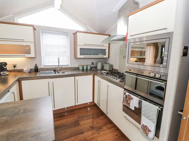 A kitchen with cabinets and countertop at No 8 Hillcote Lodge in Cockermouth