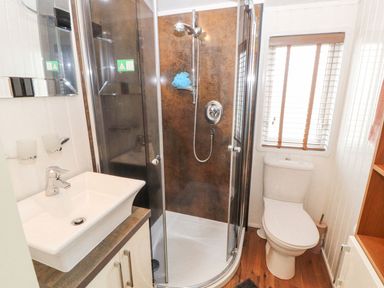 A bathroom with a shower and a toilet at No 8 Hillcote Lodge in Cockermouth