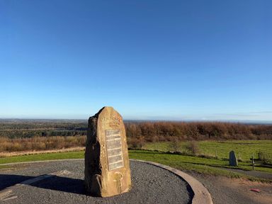 A viewpoint with a stone monument and a landscape view at Cheshire