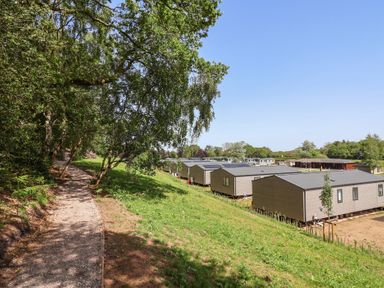 An outdoor area with a pathway and holiday homes at The Oaks 2 Bedrooms, Delamere