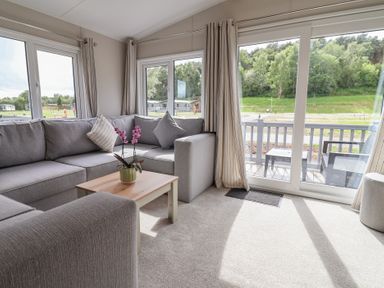 A living room with a sofa and coffee table at The Oaks 2 Bedrooms in Delamere