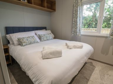 A bedroom with a double bed and window at The Oaks 2 Bedrooms Delamere