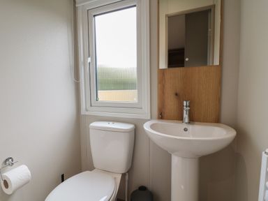 A bathroom with a toilet and sink at The Oaks 2 Bedrooms Delamere
