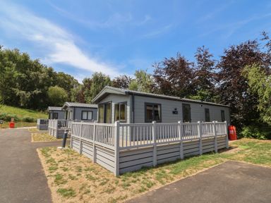 Cabins with porches in a recreational area at The Oaks 3 Bedrooms Delamere