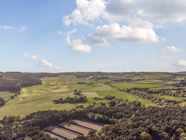 A landscape view showing fields and trees at Cedar Lodge 2 Bedrooms with hot tub in Delamere