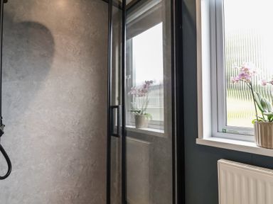 A bathroom with a shower and a window at Cedar Lodge 2 Bedrooms with hot tub Delamere