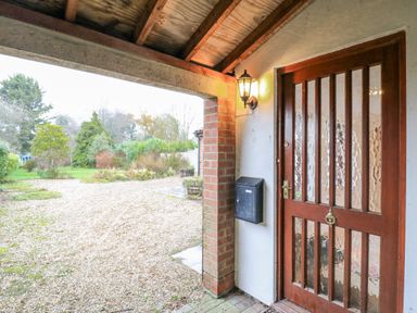 An outdoor entrance with a door and mailbox at The Pantiles in Banham