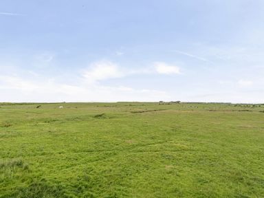 A landscape with grass and hills at Bank House Cottage Glasson Dock