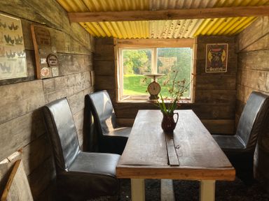 A dining room with a table and chairs at The Tree House in the Woods Longhope