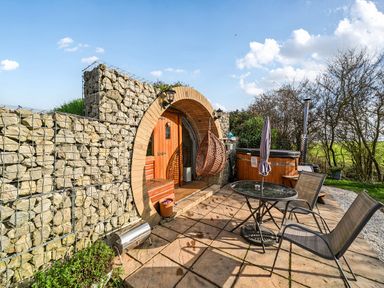 An outdoor area with a hot tub and seating at Cosy Escape Minster On Sea