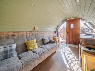 A living room with a door and sofa at Cosy Escape in Minster On Sea
