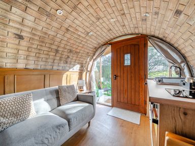A living room with a sofa and door at Cosy Escape in Minster On Sea