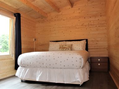 A bedroom with a bed and nightstand at Cotswold Nights Away in Evesham