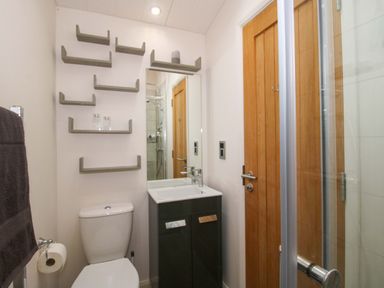 A bathroom with a toilet, sink, and shower at 5 Hillview Lodges in Cleobury Mortimer